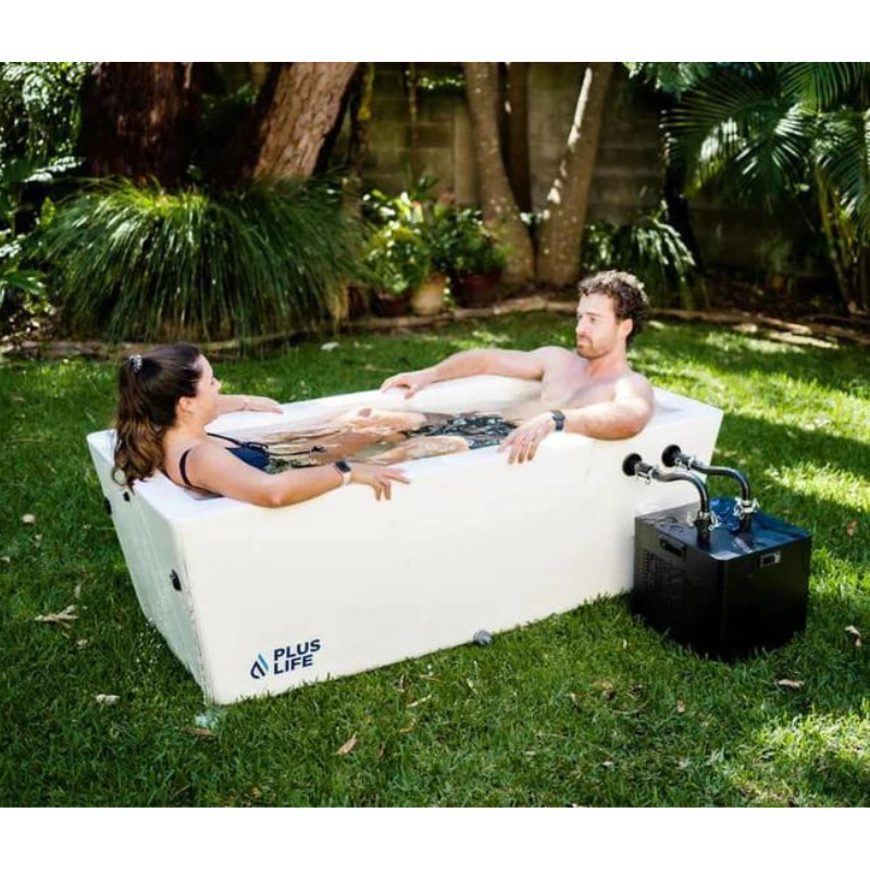 PlusLife Original Ice Bath in White Fully Assembled on grass with 2 people using it 2.png