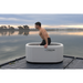 Xtreme Plunge Descent Solo Cold Plunge Inflatable Tub in Grey with ocean background and model standing inside