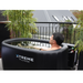 Xtreme Plunge Descent Solo Cold Plunge Tub Ultimate Package with chiller, tub and lid in Black with model using it, back view