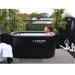 Xtreme Plunge Descent Solo Cold Plunge Tub Ultimate Package with chiller, tub and lid in Black with model using it, front view